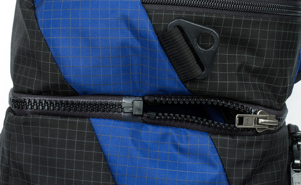 The zipper that connects the top pocket to the main bag.